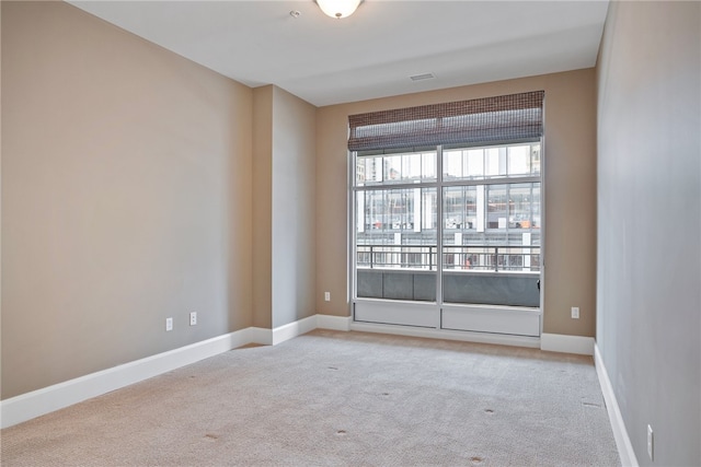 unfurnished room with light colored carpet