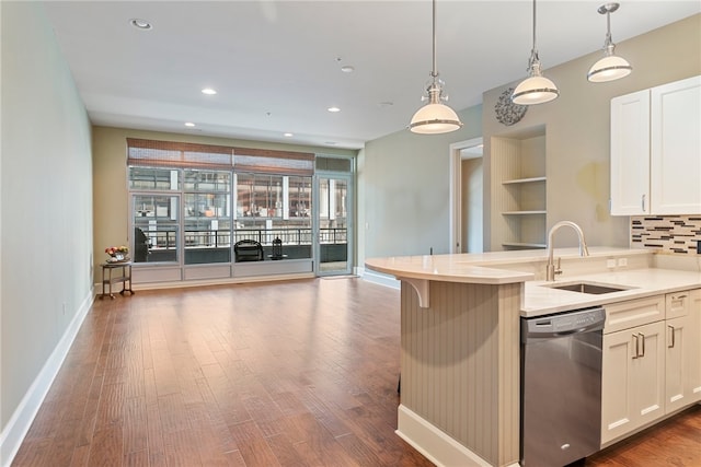 kitchen with stainless steel dishwasher, dark hardwood / wood-style floors, decorative backsplash, pendant lighting, and sink