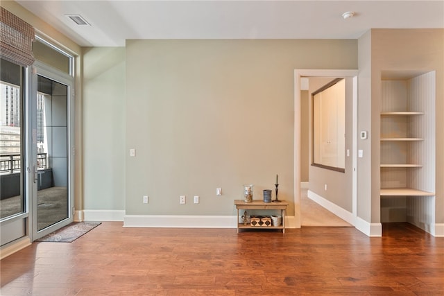 spare room with hardwood / wood-style floors