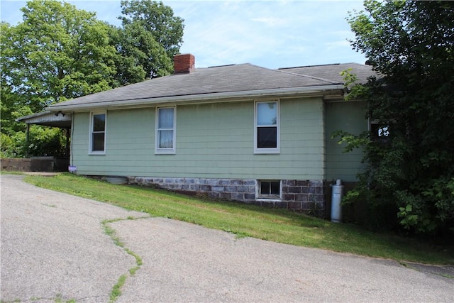 view of side of property with a yard