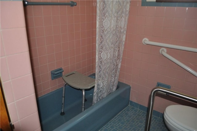 bathroom featuring shower / tub combo, tile patterned floors, tile walls, and toilet