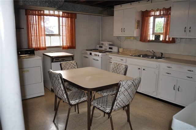 kitchen with washer / dryer, white cabinets, sink, and gas range gas stove