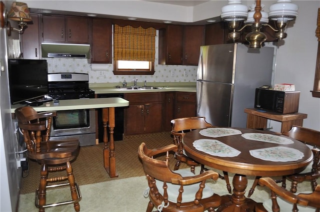 kitchen featuring range hood, stainless steel appliances, sink, and dark brown cabinets