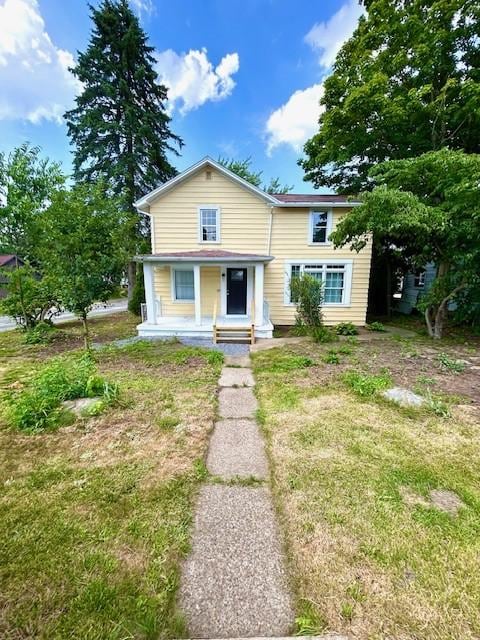 bungalow featuring a front lawn and covered porch