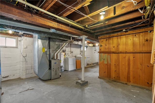 basement with water heater and independent washer and dryer