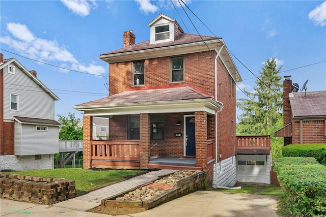 view of front of house with a garage, a front yard, and a porch