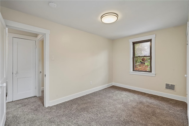 unfurnished room featuring carpet