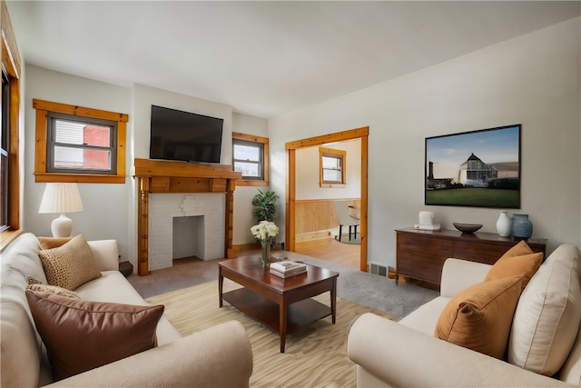 living room featuring a healthy amount of sunlight and light carpet