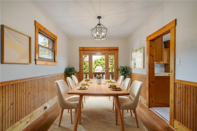 dining space featuring an inviting chandelier and light hardwood / wood-style floors