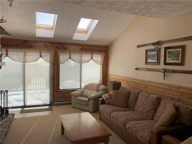 living room featuring a healthy amount of sunlight, lofted ceiling, wooden walls, and a baseboard radiator