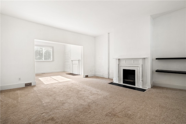 unfurnished living room featuring light colored carpet