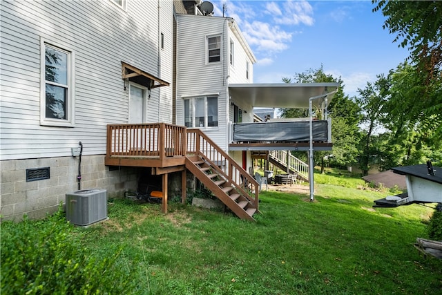 back of house with cooling unit, a deck, and a yard