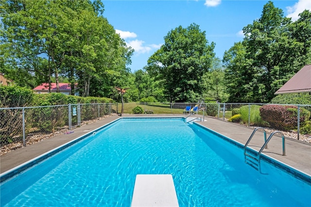 view of pool featuring a diving board