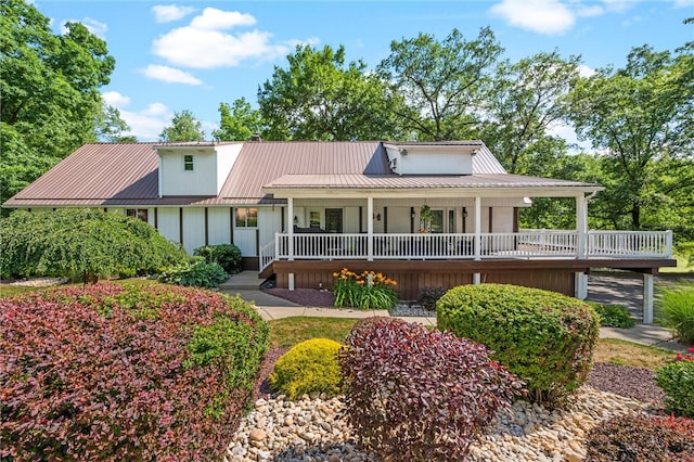 rear view of house featuring a porch