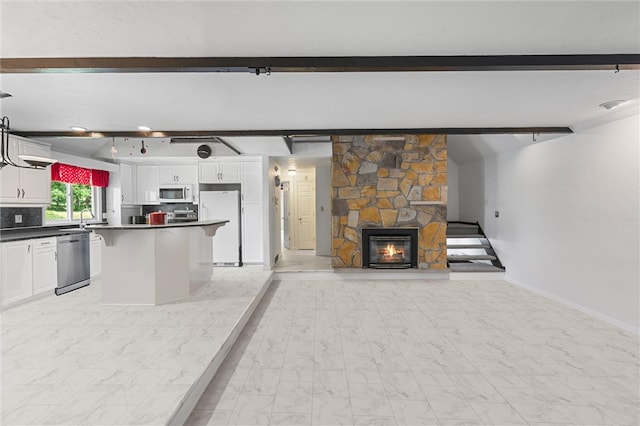 kitchen featuring beam ceiling, white cabinets, white appliances, and light tile flooring