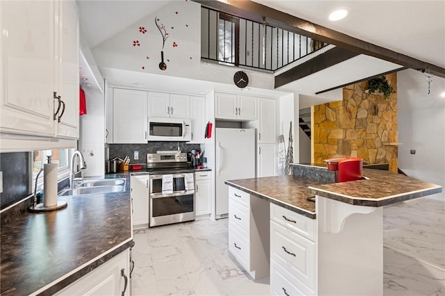 kitchen with a kitchen breakfast bar, white appliances, white cabinetry, and backsplash