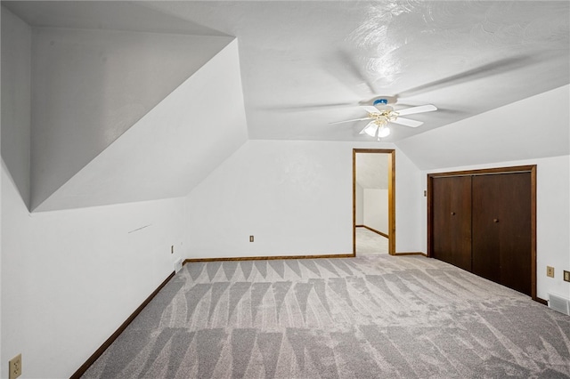 additional living space featuring lofted ceiling, carpet, and ceiling fan