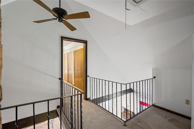 stairway with lofted ceiling, carpet floors, and ceiling fan