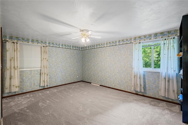 spare room featuring carpet and ceiling fan