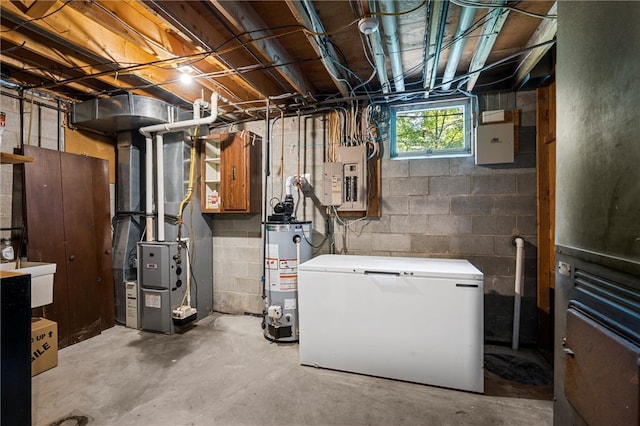 basement with water heater, sink, refrigerator, and heating utilities