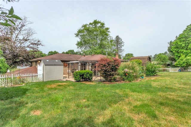 exterior space featuring a lawn and a storage shed