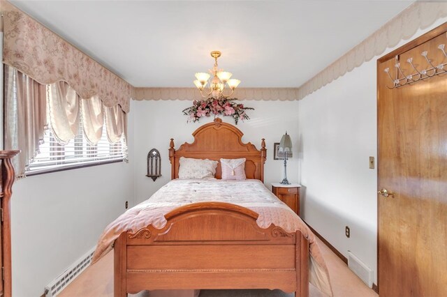 bedroom with carpet and a chandelier