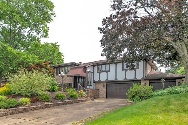 tudor house featuring a garage and a front yard