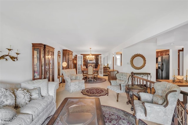 carpeted living room featuring a notable chandelier