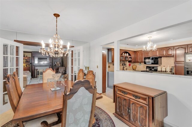 dining room featuring a chandelier and light tile floors