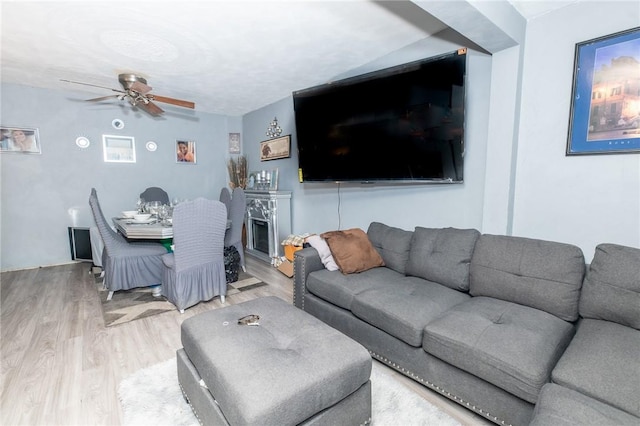 living room featuring ceiling fan and hardwood / wood-style flooring