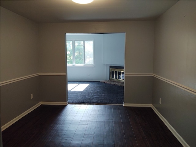 unfurnished room featuring dark hardwood / wood-style flooring