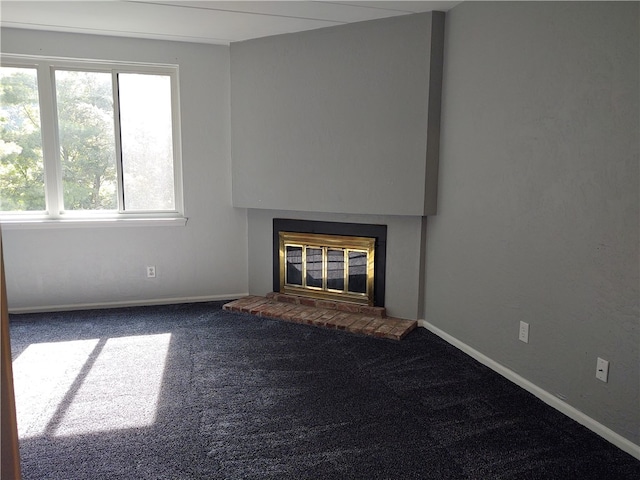 unfurnished living room with a fireplace and carpet