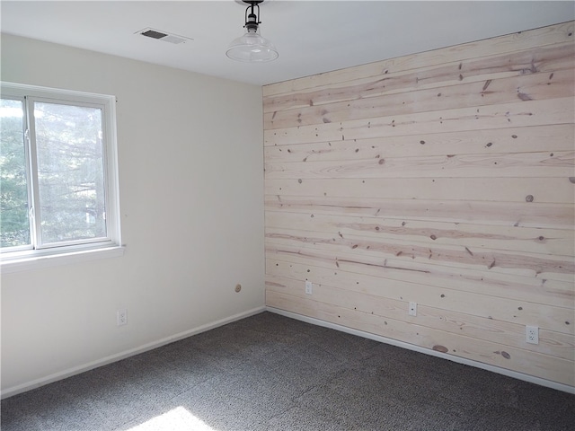 empty room featuring wood walls