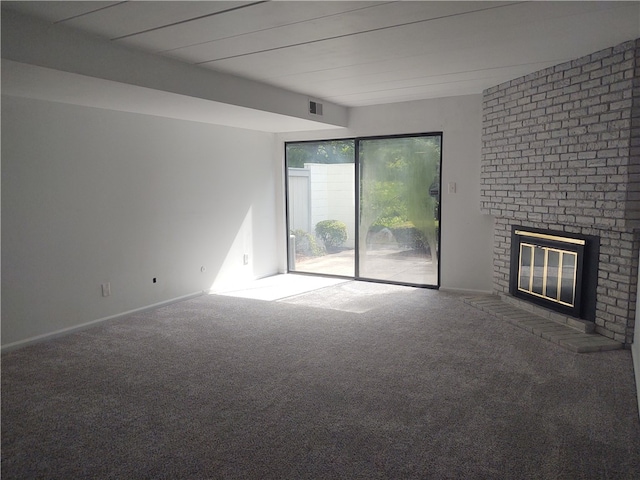 unfurnished living room with carpet flooring and a brick fireplace