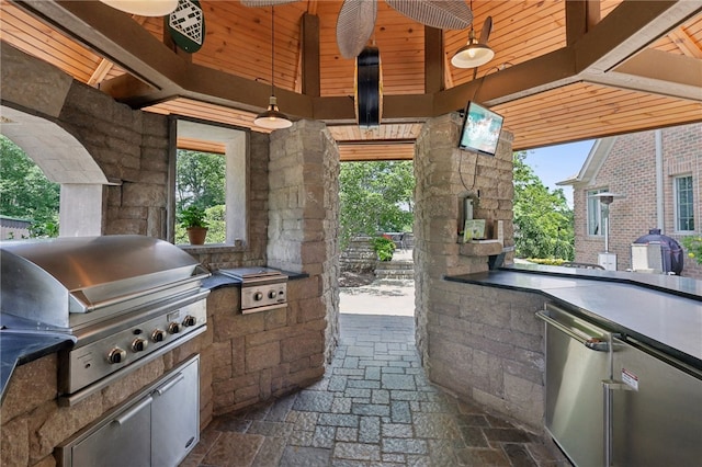 view of terrace featuring grilling area, ceiling fan, and an outdoor kitchen