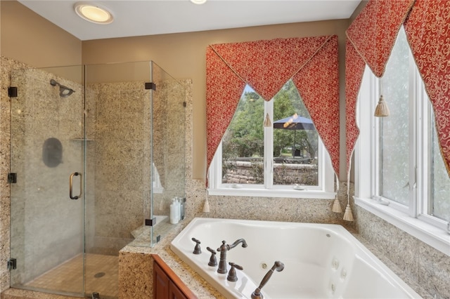 bathroom with a wealth of natural light and walk in shower