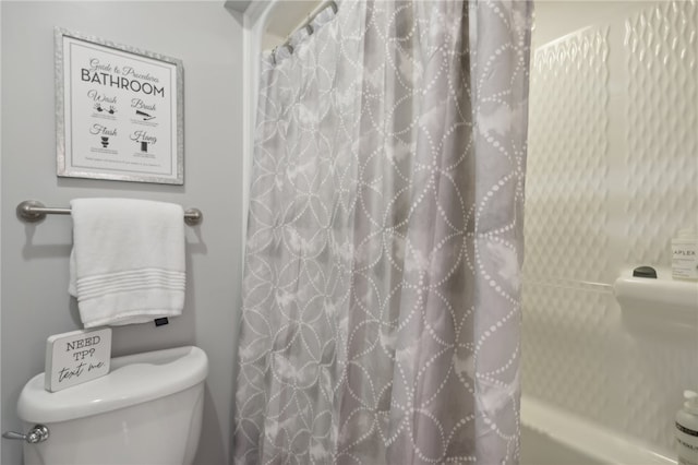 bathroom with shower / bath combination with curtain and toilet