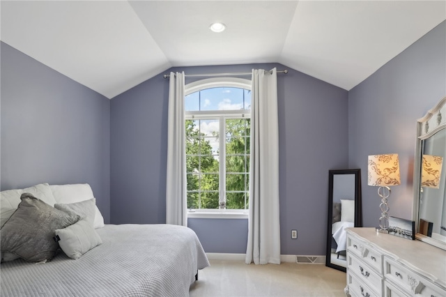 carpeted bedroom featuring lofted ceiling