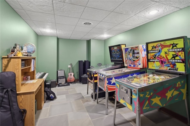 rec room featuring light tile floors and a drop ceiling