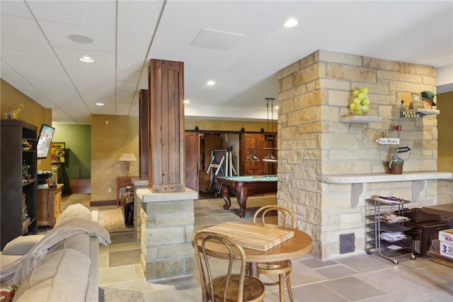 tiled living room with billiards and a barn door