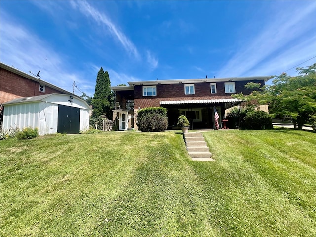 view of front of home with a front yard and an outdoor structure