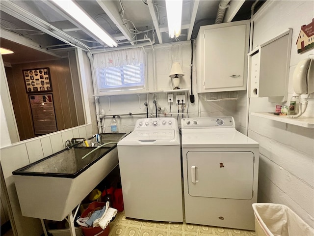 washroom featuring washer and dryer, cabinets, sink, and hookup for a washing machine