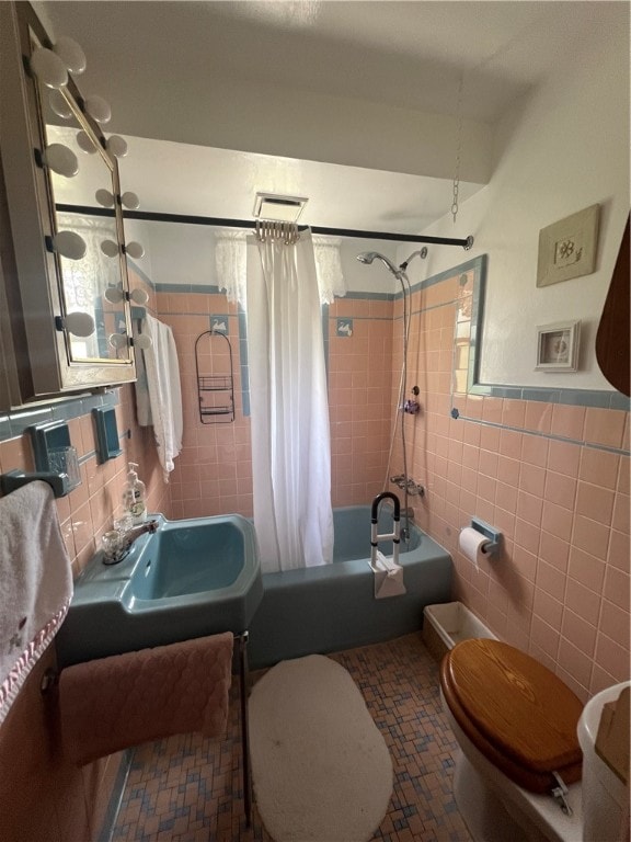 full bathroom featuring tile walls, tasteful backsplash, toilet, tile floors, and shower / tub combo