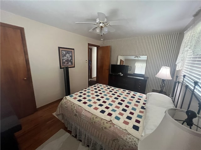 bedroom with hardwood / wood-style flooring and ceiling fan