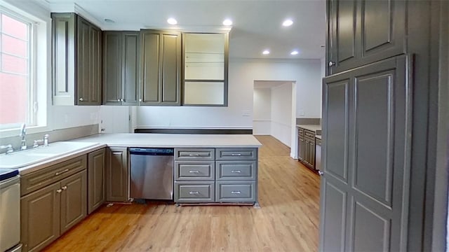 kitchen with dishwasher, a healthy amount of sunlight, light hardwood / wood-style floors, and sink