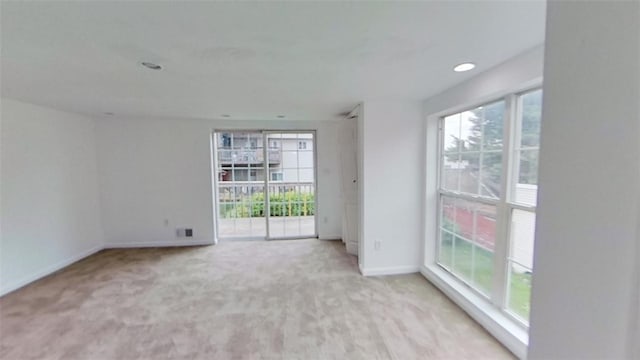 empty room featuring light carpet