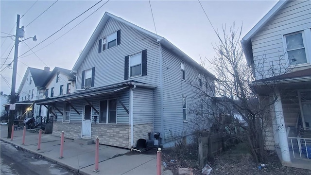 view of side of home with a porch