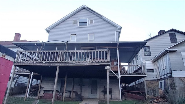 rear view of house with a wooden deck