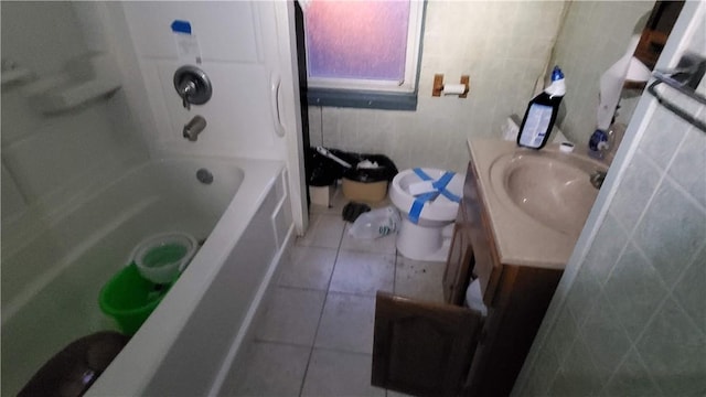 bathroom featuring tile patterned flooring, vanity, and washtub / shower combination