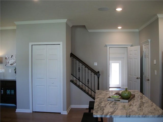 foyer entrance featuring crown molding and dark hardwood / wood-style flooring